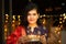 Portrait of Happy Young indian gorgeous woman hold plate/thali with diya/clay oil lamps wearing traditional dress,celebrates