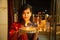 Portrait of Happy Young indian gorgeous woman hold plate/thali with diya/clay oil lamps wearing traditional dress,celebrating