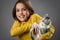 Portrait of happy young little girl with calico kitten cat