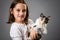 Portrait of happy young little girl with calico kitten cat