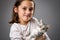 Portrait of happy young little girl with calico kitten cat