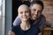 Portrait of happy young man hugging beloved woman with cancer