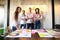 Portrait of happy young people in a meeting looking at camera and smiling. Young designers working together on a