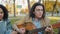 Portrait of happy young people singing playing the guitar in city park in autumn