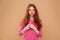 Portrait of a happy young redhead girl holding paper lips