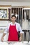 Portrait of a happy young skilled worker standing with meter stick in workshop