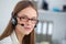 Portrait of happy young support phone operator with headset.