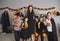 Portrait of happy young woman and children in spooky costumes at Halloween party