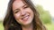 Portrait of happy young woman outdoors in summer