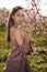 Portrait of a happy young woman in peach field