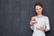 Portrait of happy young woman pointing at saucer with ripe peach