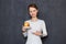 Portrait of happy young woman pointing at saucer with yellow-red apple