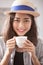 portrait head shot of beautiful younger asian woman and hot coffee cup in hand happiness emotion