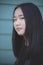 Portrait headshot of asian teenager looking with eyes contact to camera