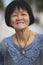 Portrait headshot of old asian woman toothy smiling face