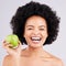 Portrait, health and black woman with apple, diet and happiness against a grey studio background. Face, African American