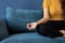 Portrait of healthy Asian woman meditating and exercise pose yoga on the sofa in morning. Zen relaxation and mindfulness lifestyle