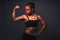 Portrait of healthy athletic 40 year old asian woman with a lean muscle and nice six pack core body lifting her strong right arm