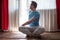 Portrait of healthy young man doing yoga Spine twisting pose