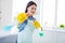 Portrait of her she nice attractive cheerful cheery funny funky housewife cleansing using spray sanitizing having fun