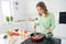 Portrait of her she nice attractive lovely cheerful focused wavy-haired girl cooking homemade dish mixing stirring