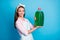Portrait of her she nice attractive pretty cheerful cheery maid carrying holding in hands liquid soap utensil chemical