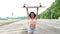 Portrait of a hipster young girl smiling with a longboard. Slow motion