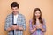 Portrait of his he her she nice attractive focused excited addicted cheerful cheery couple wearing checked shirt