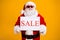 Portrait of his he nice attractive cheerful cheery confident fat Santa holding in hands board sale advert announcement