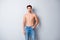 Portrait of his he nice attractive content muscular shirtless guy dandy perfect figure form shape pecs wearing jeans