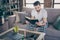 Portrait of his he nice attractive focused bearded guy sitting on divan reading interesting book spending weekend free