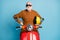 Portrait of his he nice attractive funky cheerful cheery content cool bearded grey-haired man hipster sitting moped