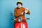Portrait of his he nice attractive funky cheerful cheery glad bearded grey-haired man riding moped holding in hand clock