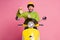 Portrait of his he nice attractive glad cheerful cheery guy sitting on moped holding in hand demonstrating recommending