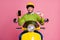 Portrait of his he nice attractive glad confident cheerful cheery guy riding moped holding in hands cell bank card e