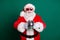 Portrait of his he nice attractive handsome cheerful Santa grandfather mc pj father having fun holding in hands silver