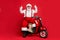 Portrait of his he nice bearded cheerful cheery funky confident Santa Claus hipster sitting on motor bike showing