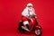 Portrait of his he nice bearded cool cheerful funky Santa hipster riding retro moped December ho-ho-ho North Pole
