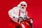 Portrait of his he nice bearded grey-haired cheerful glad funky Santa hipster riding motor bike spending cool December