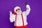 Portrait of his he nice funny cheerful cheery bearded Santa taking making selfie showing v-sign travel trip blogging