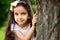 Portrait of hispanic girl in sunny park