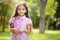 Portrait of hispanic girl in sunny park