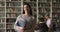 Portrait of Hispanic student girl standing in campus library