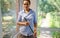 Portrait of a homemaker, maid, housewife posing at camera with broom and mop in her hands. Housekeeping concept