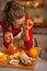 Portrait of housewife laughing while eating orange jam in kitchen