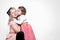 Portrait of a hugging mother and daughter dressed in beautiful dresses in retro style