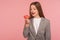 Portrait of hungry woman, office worker in business suit looking at sweet doughnut with desire