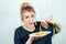 Portrait of a hungry, young and beautiful blonde woman holding a burger cheeseburger on a plate in a black T-shirt and