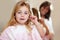 Portrait, hygiene and a child cleaning ears with an earbud in a home bathroom for grooming. Smile, cotton and a girl or