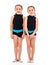 Portrait of identical twin girls dressed in rhythmic gymnastics dress